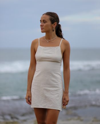 Experience the essence of the Himalayas with Higher Himalayan's eco-conscious hemp mini dress. Handcrafted from ethically sourced, organic Himalayan hemp, this off-white dress epitomizes minimalist elegance. Its square neckline and delicate straps create a look that's both sexy and decent, perfect for the eco-aware young adult. The back's adjustable tie closure hints at the hand-made care and attention to detail by designers Chathu and Hui. Ideal for beachgoers or those indulging in yoga and meditation, this dress blends the durability of hemp with the comfort of natural fibers, inviting wearers to elevate their style while embracing a sustainable, slow fashion lifestyle